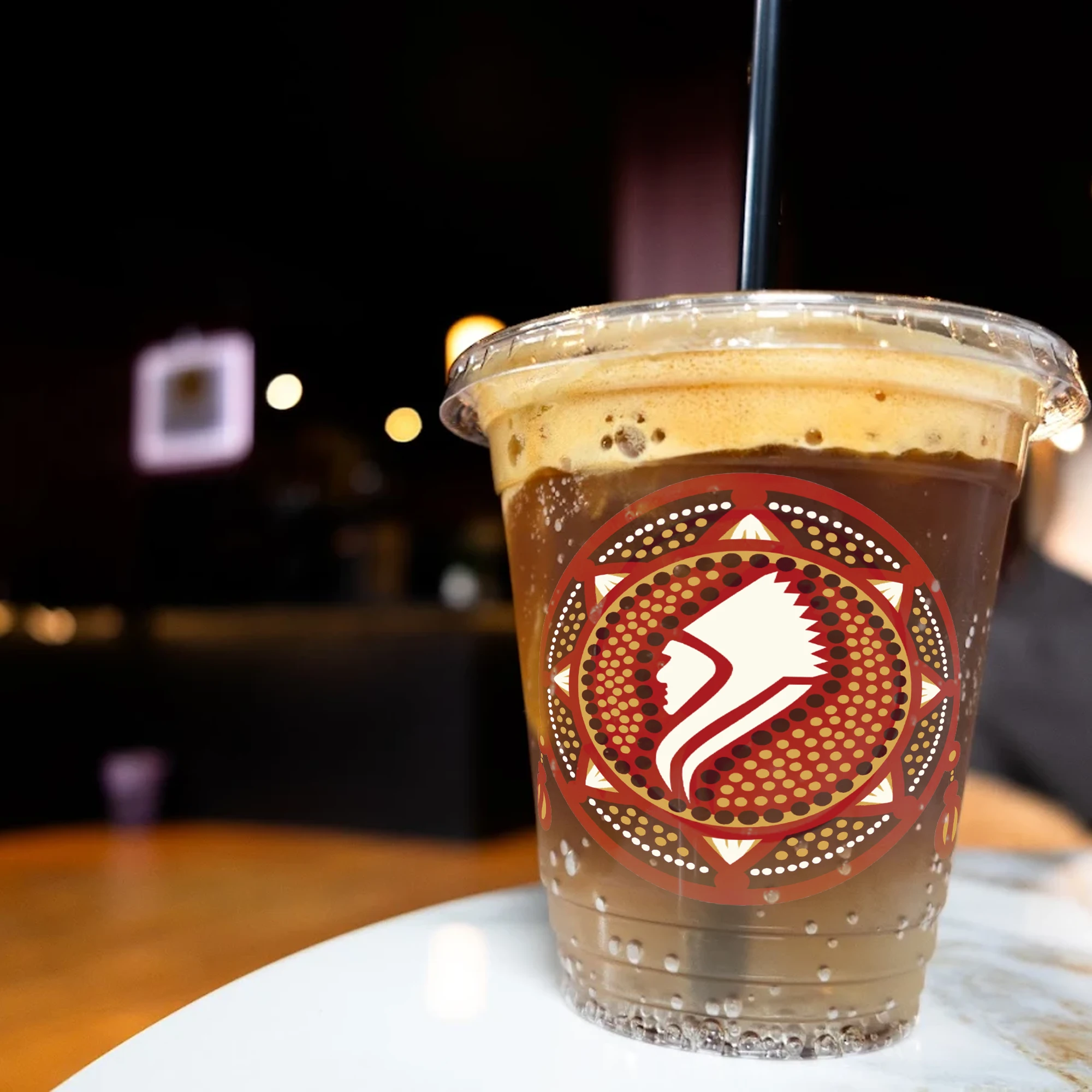 Iced coffee in a clear cup bearing the Coffee Chief emblem.